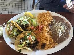 Acopio Restaurant signature dishes Mole Poblano Con PatoTacos Al PastorPapas Doradas